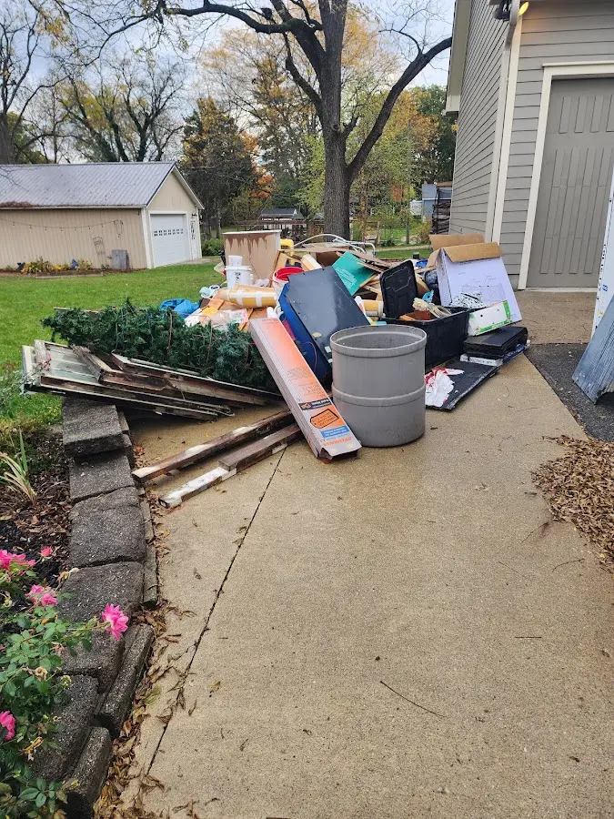 Dumpster being loaded with debris for 12 Yard Dumpster Rental in Finley